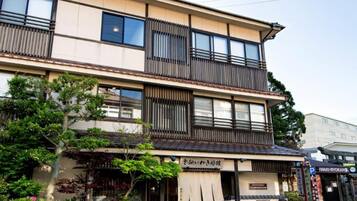A multi-story building with a commercial ground floor and a residential upper floor.