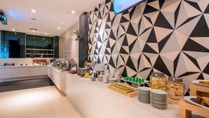 A modern hotel room with a large bed, a bedside table, and a nightstand. - Hotel 88 Mangga Besar 120 (Jakarta)
