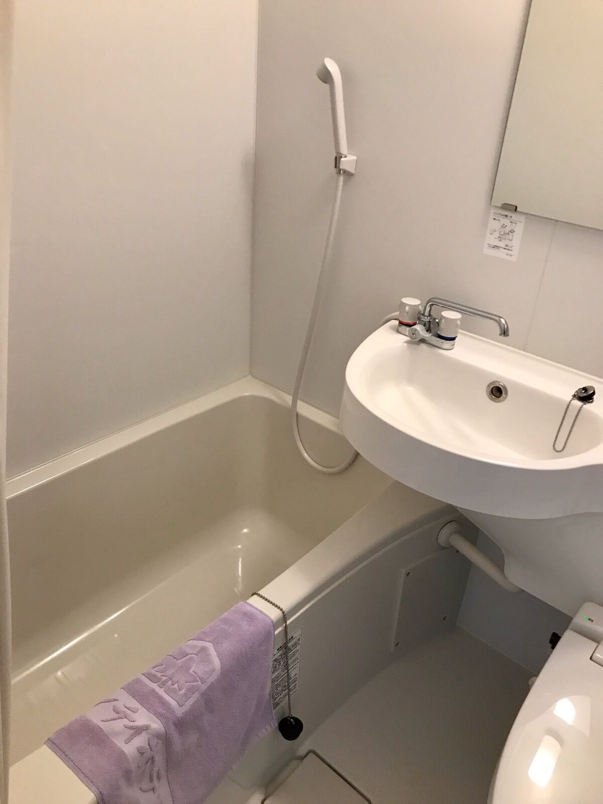 A bathroom with a bathtub, a sink, and a shower.