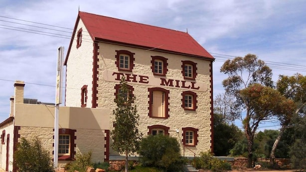 A two-story building with the sign "THE MILL" on the facade. - Flinders Ranges Motel (Quorn)