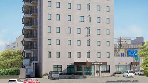 A multi-story hotel with a prominent yellow sign on the top. - Smile Hotel FukuokaOkawa (Okawa)