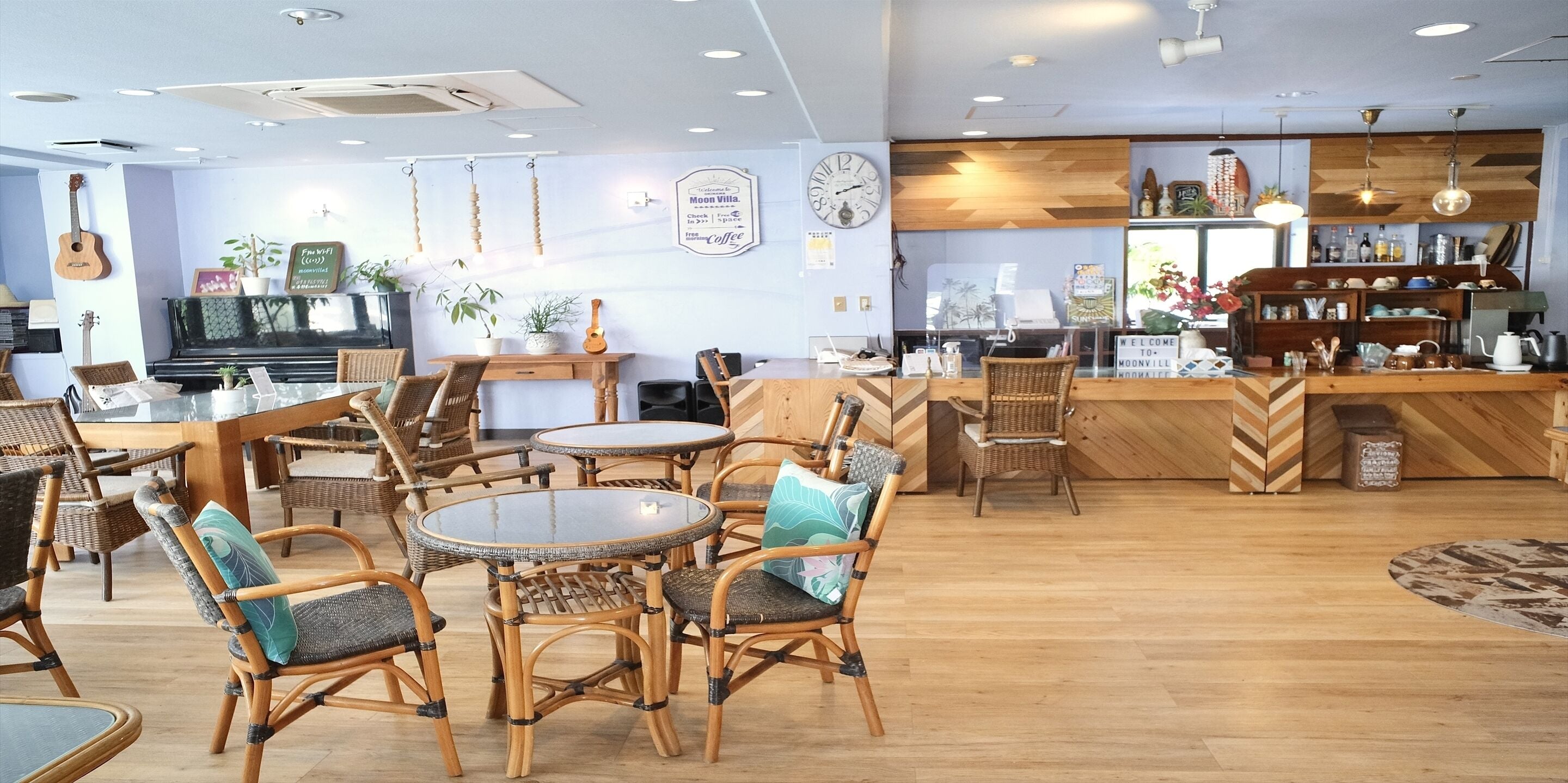 A cozy cafe with wooden furniture, a piano, and a welcoming sign.