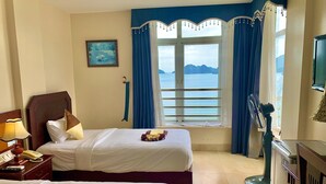 A hotel room with two beds, a large window with curtains, a painting on the wall, and a television on the wall. - Hung Long Harbour Hotel (Hai Phong)