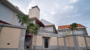 A building with a sign reading "griya SUNSET KUTA" and a number "29" on the wall. - Griya Sunset Kuta (Kuta)