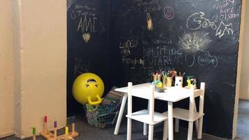 Learn and play in this vibrant classroom with a blackboard, exercise ball, and educational tools.