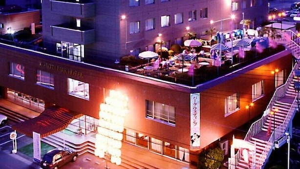 A multi-story hotel with a prominent sign at the top. - Akita Park Hotel (Akita)