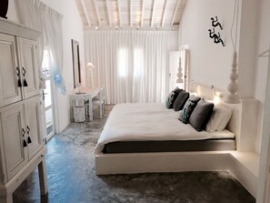 A bedroom with a large bed, a desk, and a wardrobe. - W15 Escape (Ahangama)