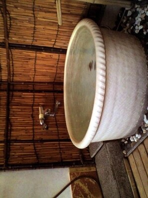 A bathroom with a large ceramic sink, a bamboo ceiling, and a tiled floor. - Shikikaoru Yado Sadae (Kami)