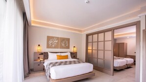 A modern hotel room with a large bed, bedside lamps, and a sliding door closet. - Pgs Hotels Casa Del Sol (Kata)