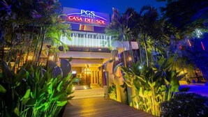The exterior of PGS Hotels Casa Del Sol with a well-lit entrance and tropical plants. - Pgs Hotels Casa Del Sol (Kata)