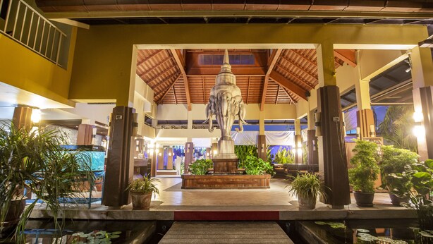 A courtyard with a central statue, potted plants, and a covered walkway. - Pgs Hotels Casa Del Sol (Kata)