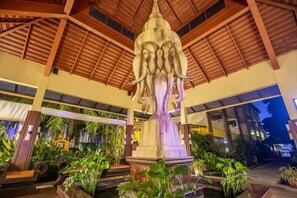 A large indoor fountain with a statue of an elephant, surrounded by lush greenery and wooden architectural elements. - Pgs Hotels Casa Del Sol (Kata)