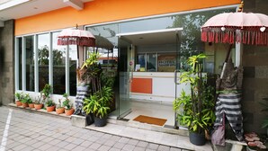 A hotel entrance with glass doors, potted plants, and a sign reading "Hotel Sanur Ayu". - Sanur Ayu Hotel (Denpasar)