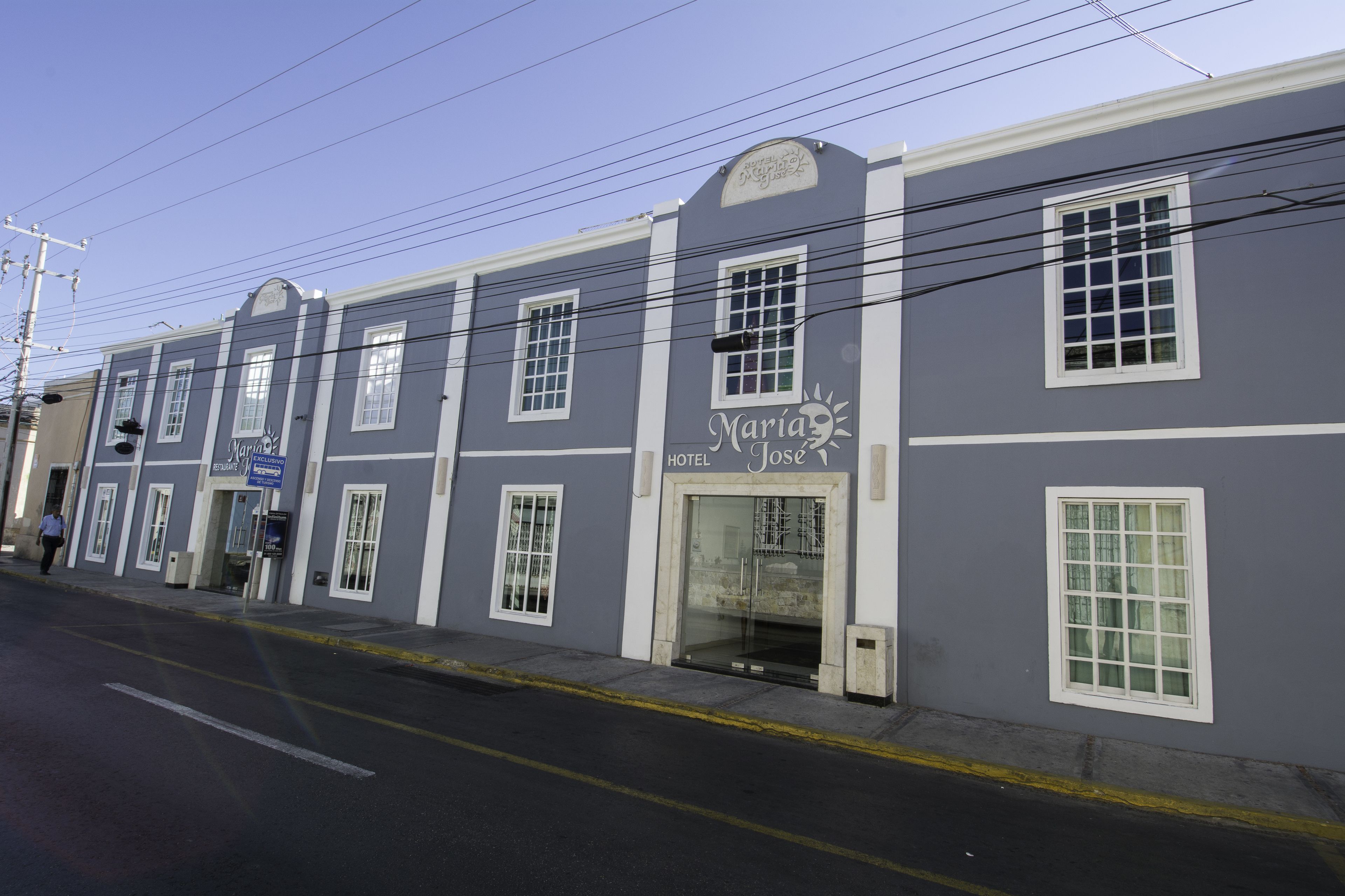 A hotel named Maria Jose with a classic facade, multiple windows, and a visible entrance.