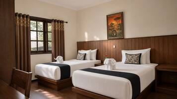 A hotel room with two beds, a wooden headboard, a painting on the wall, and a window with curtains.