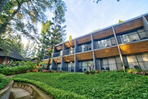 A modern building with multiple balconies, surrounded by lush greenery and a well-maintained garden. - Royal Safari Garden Resort & Convention (Cisarua)