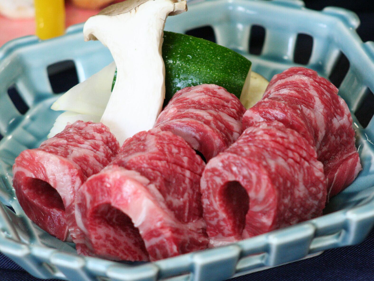 A bowl of sliced meat and vegetables.