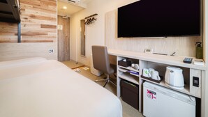 A hotel room with a bed, a desk with a coffee maker, a TV, and a shower area. - Super Hotel Shinagawa Aomonoyokocho (Tokyo)