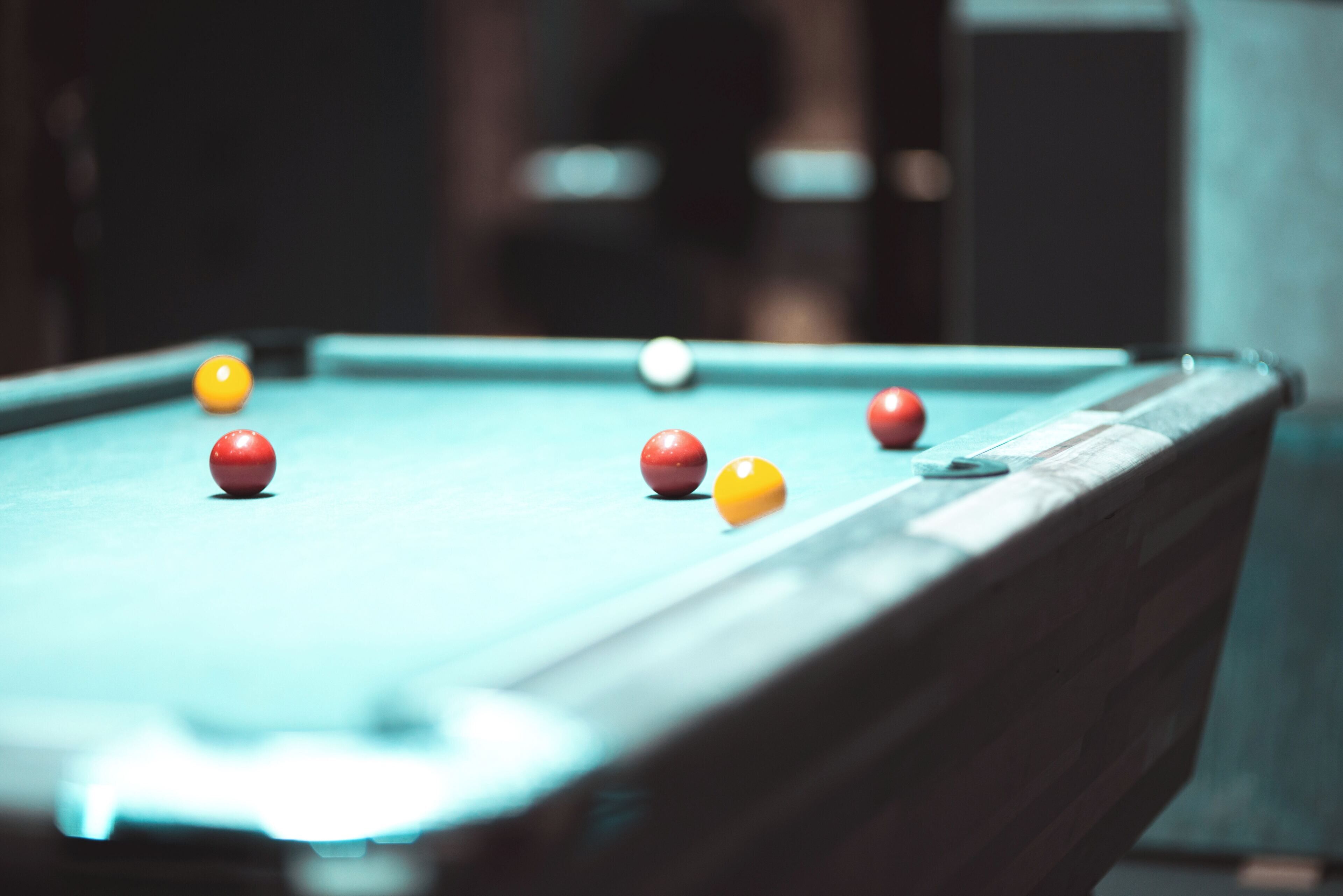 A pool table with balls in various colors.