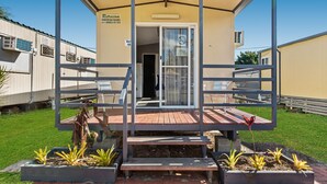 A single-story building with a covered entrance, a small porch, and a sign indicating 'Unit 4A'. - Yandina Caravan Park (Sunshine Coast)