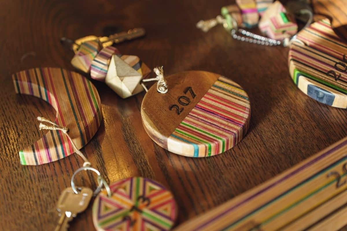 A wooden surface with various striped and patterned objects, including a round wooden piece with the number '207' on it.