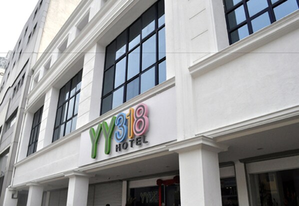 A hotel with a modern facade, large windows, and a prominent sign reading "YY318 HOTEL". - YY318 Hotel Bukit Bintang (Kuala Lumpur)