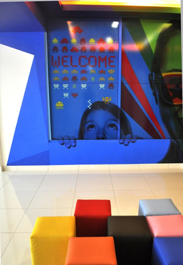 A colorful reception area with a 'WELCOME' sign and a large window. - YY318 Hotel Bukit Bintang (Kuala Lumpur)