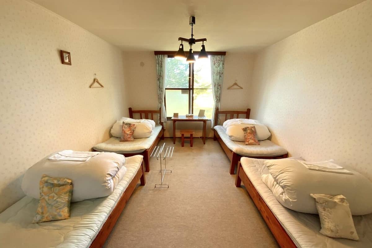A room with two sofas facing each other, a small table, and a hanging light fixture.