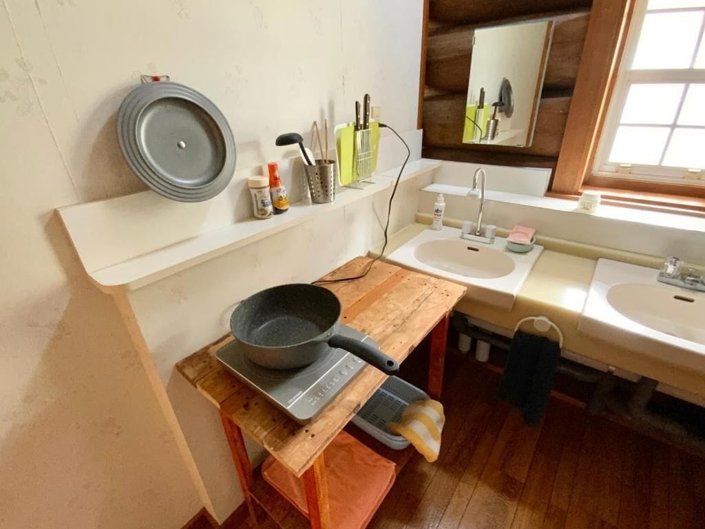 A kitchen with a stove, sink, and wooden countertop.