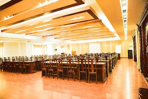 A large conference room with rows of wooden tables and chairs, high ceilings with exposed beams, and a polished wooden floor. - Linh Phuong 8 Hotel (Can Tho)