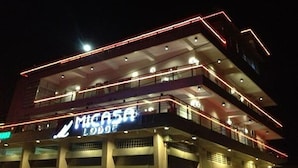 A multi-story building with a prominent sign for "Migasa Lodge." - Micasa Lodge Palawan (Coron)
