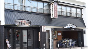 A building with a sign reading "mura ya" and another sign above the entrance.