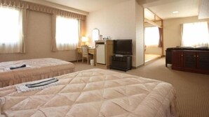 A hotel room with two beds, a desk, a television, and a wardrobe. - Nogami President Hotel (Iizuka)