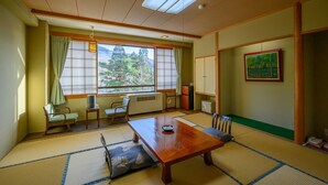 A traditional Japanese room with tatami flooring, a low table, and sliding doors. - Sakaiya Mori no Hotel Wald Berg (YAMAGATA)