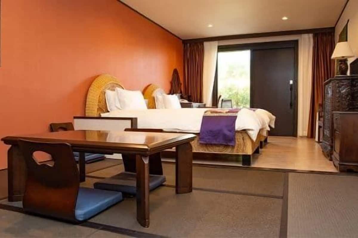 Une chambre d’hôtel avec un lit, un bureau et une chaise.