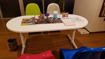 Cozy retreat with a table for games and relaxation, featuring a comfortable seating area and thoughtful touches.