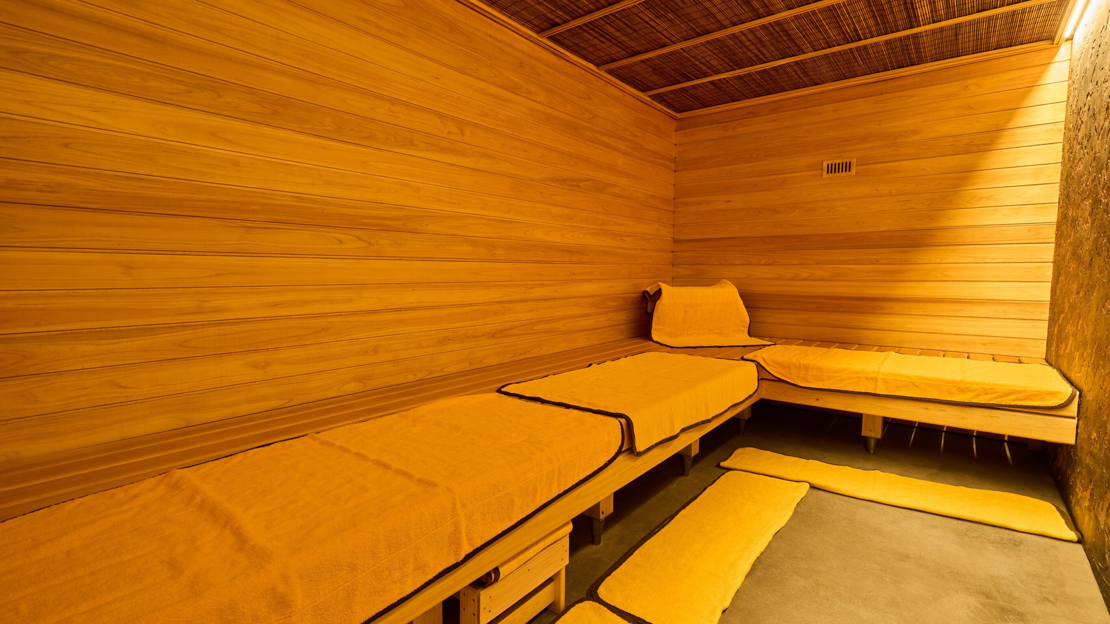 Una sauna con pareti e panche in legno.