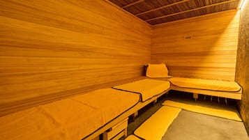 Uma sala de sauna com paredes e bancos de madeira.