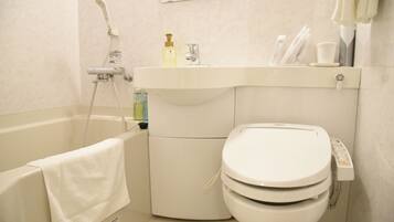 A bathroom with a bathtub, a toilet, and a sink.