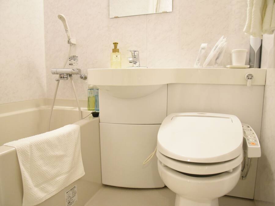 A bathroom with a bathtub, a toilet, and a sink.