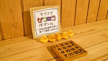 A wooden table with a sign, rubber ducks, and a wooden block with numbers.