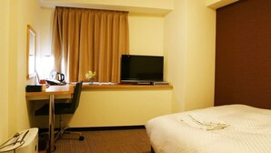 A hotel room with a bed, a desk with a computer and a television, a window with curtains, and a wall-mounted mirror. - Century Art (Fukuoka)