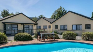 A two-story building with a swimming pool in front. - Ashleigh Court Motel (Blenheim)