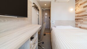 A hotel room with a wooden headboard, a bed with white bedding, a desk with a chair, a flat-screen TV mounted on the wall, and an air conditioning unit on the ceiling. - SUPER HOTEL Kushiro Kurogane (Kushiro)