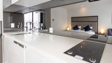 A modern kitchen with a large island, built-in dishwasher, and a gas stove.