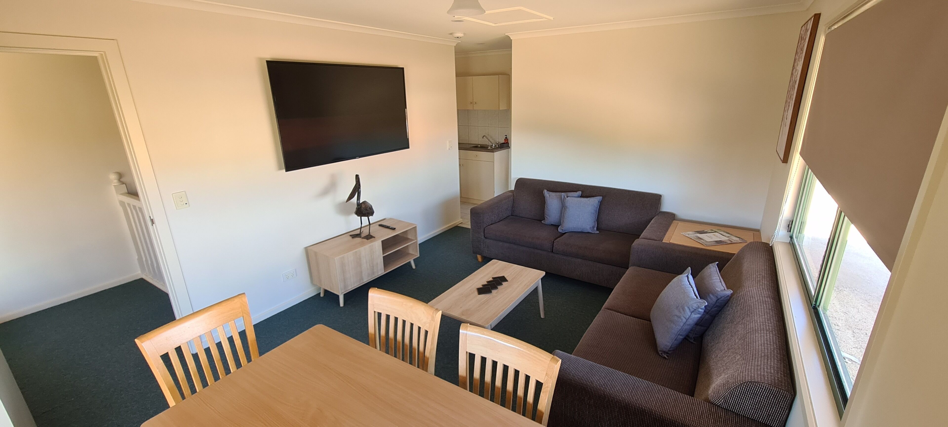 A living room with a sofa, coffee table, and TV.