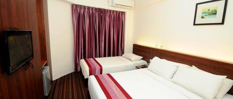 A hotel room with two beds, a television, an air conditioning unit, and a framed picture on the wall.