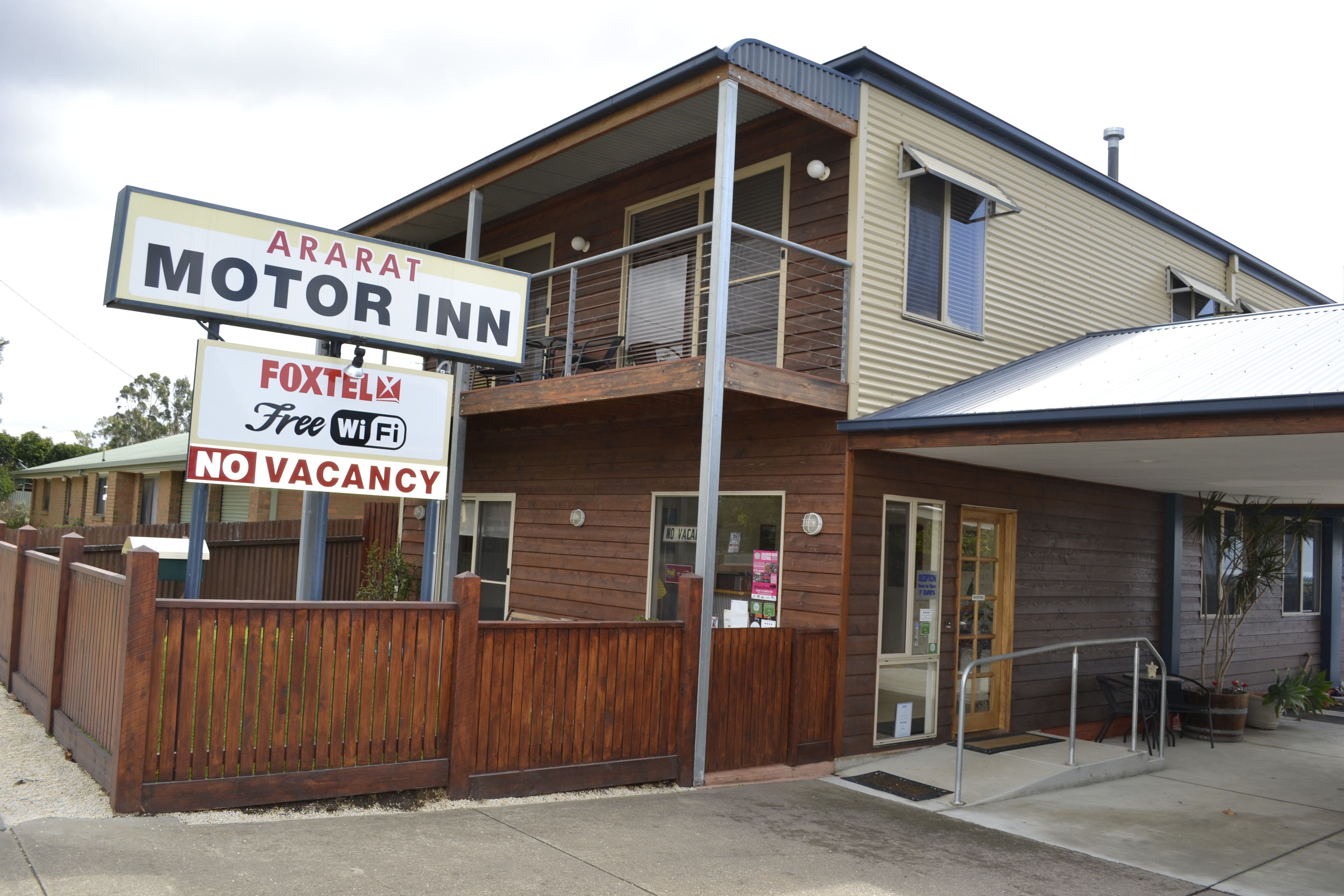 A two-story building with a sign for 'Motor Inn' and 'Foxtelex Free Wi-Fi'.