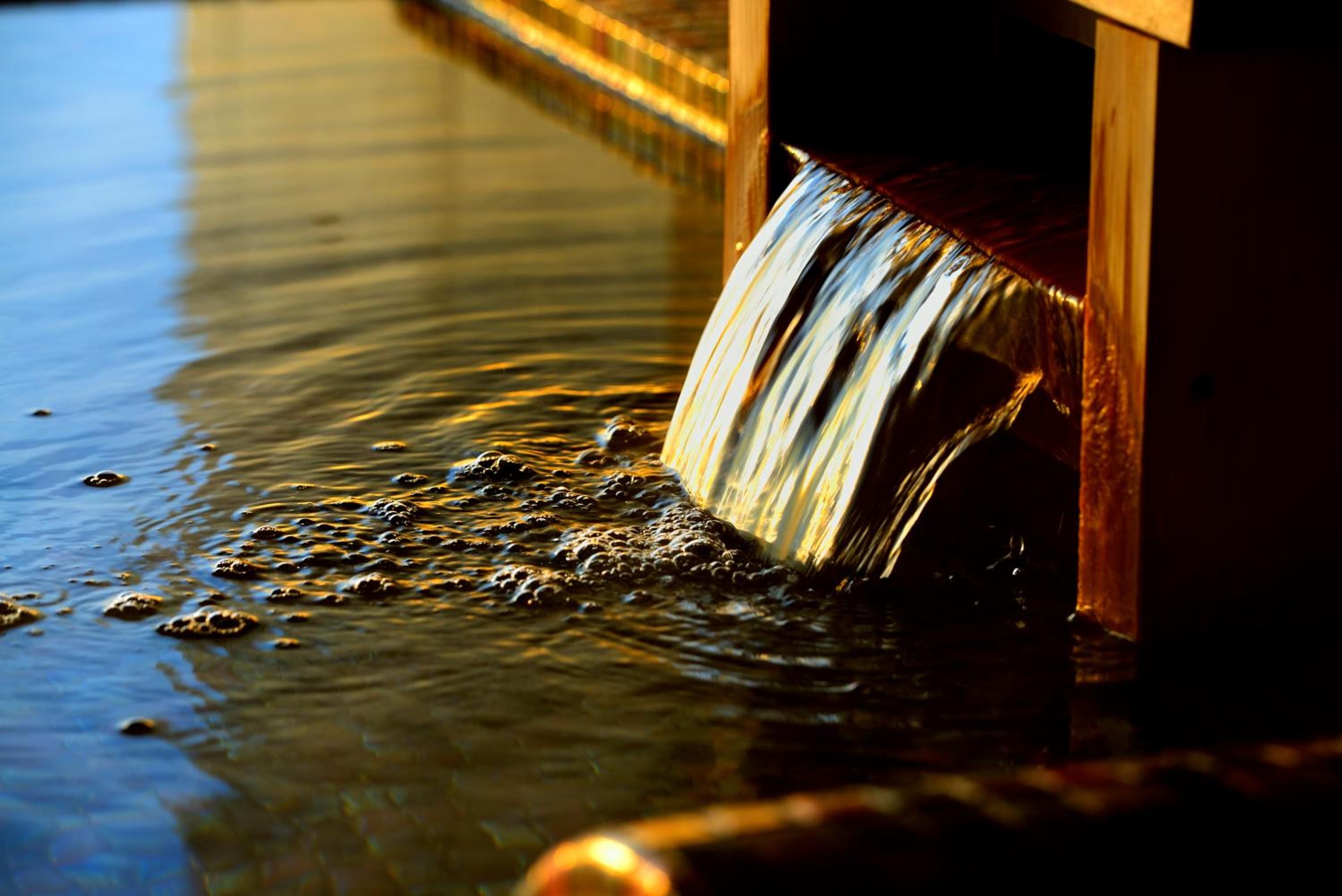 A water feature with a wooden structure and flowing water.