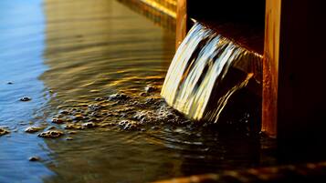 A water feature with a wooden structure and flowing water.